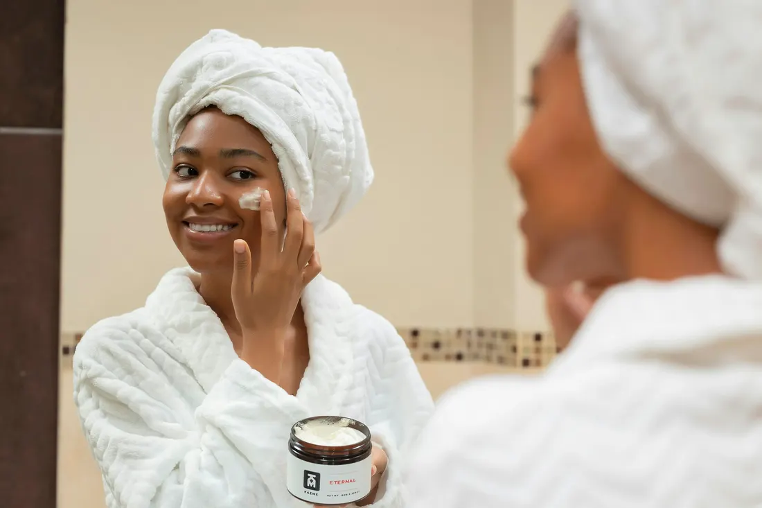 A woman with a towel wrapped around her hair during a facial