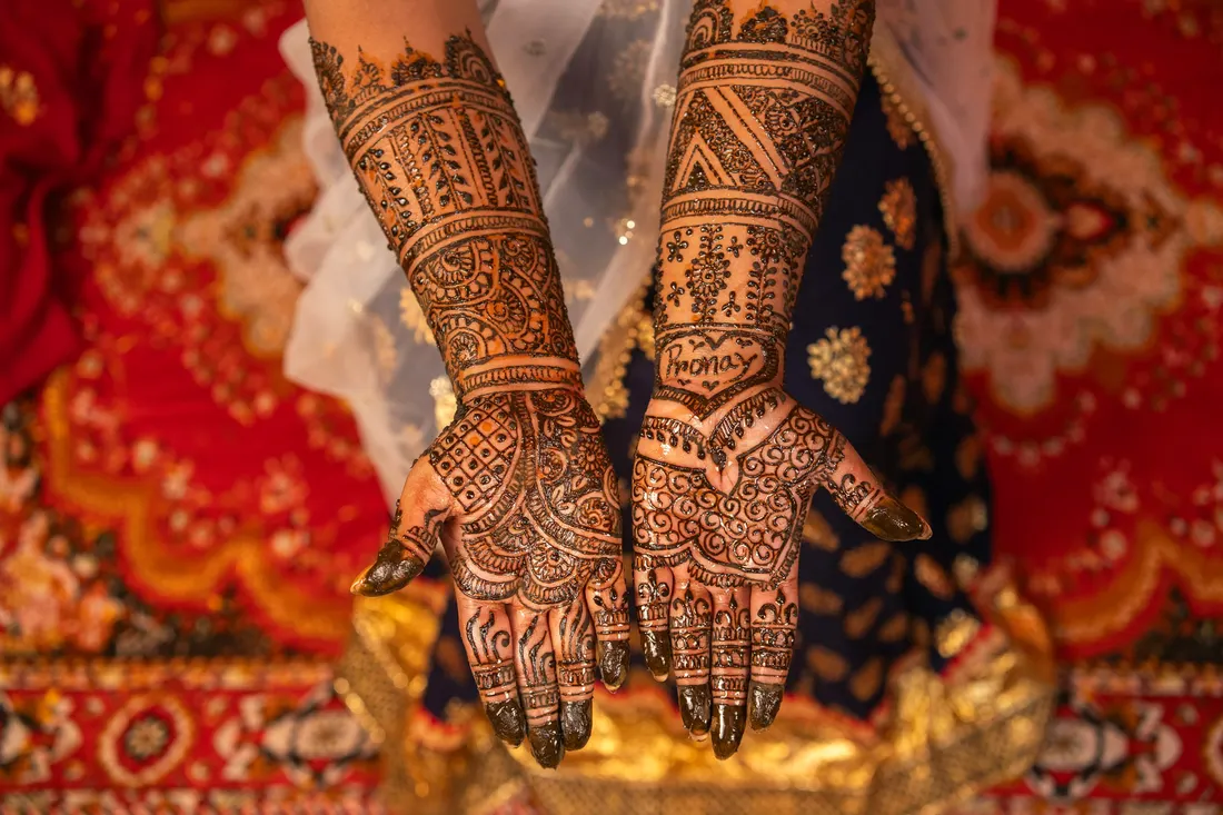 Close-up of hands decorated with henna