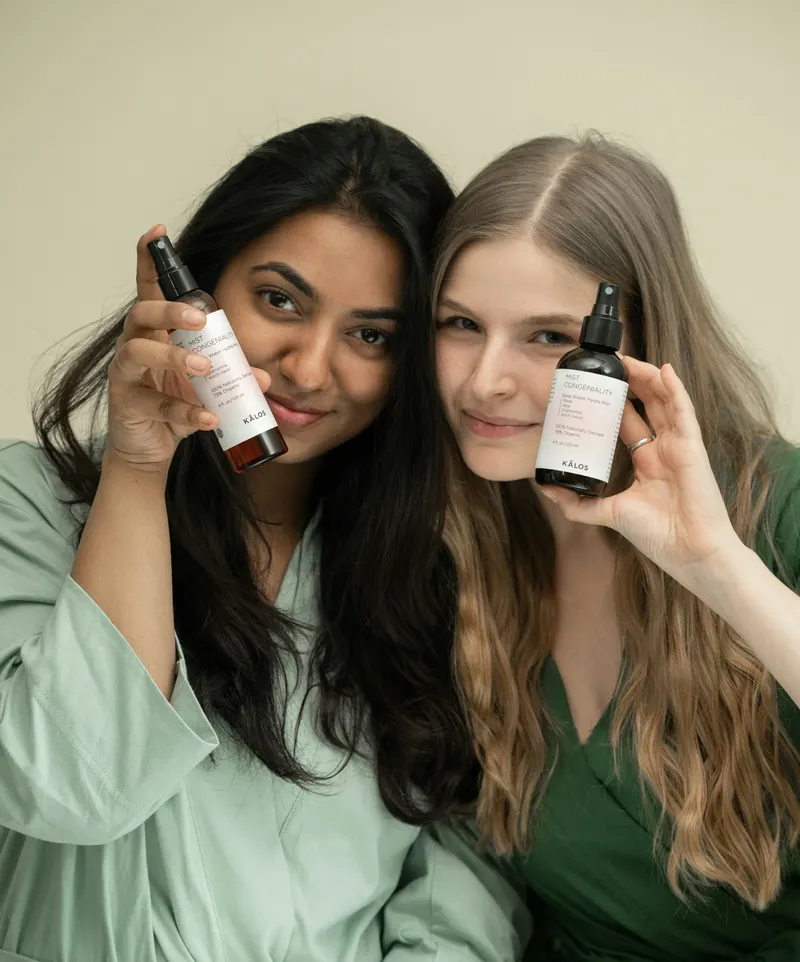 A woman holding a skincare bottle
